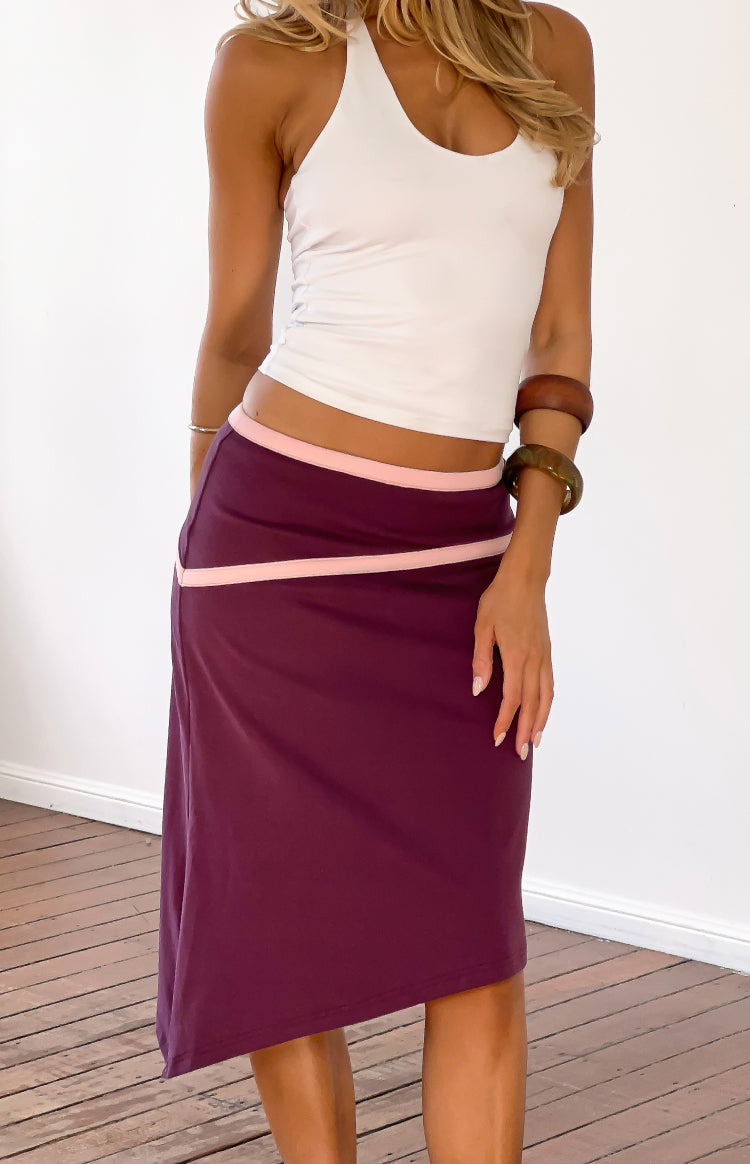 Beginning Boutique Levi Grape Contrast Bind Asymmetric Skirt grape midi skirt with pink contrast binding on waist and an asym