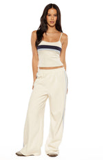 Front view of white wide-leg pants with light blue side stripes and elasticated waist