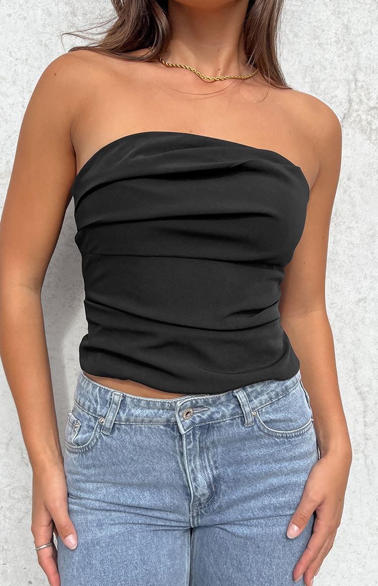 Close-up of the black strapless top showing the horizontal ruching detail and fitted hem