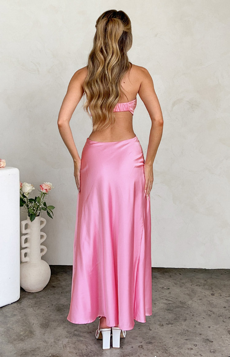 Rear view of a pink satin maxi dress showing the strapless shirred top and open back