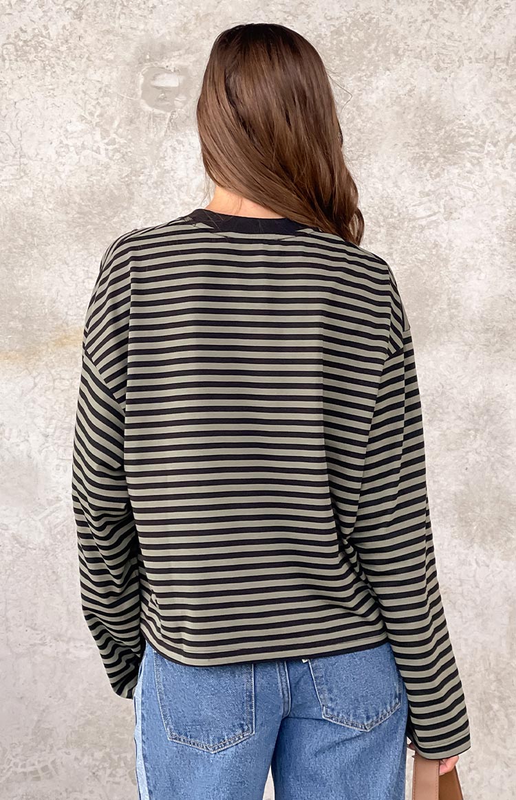 Rear view of a black and forest green striped long sleeve top with a relaxed fit