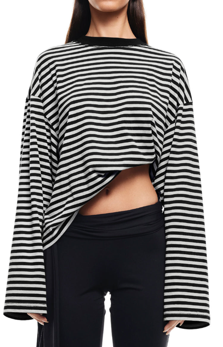 Black and white striped long sleeve top with an oversized fit and an asymmetrical hem