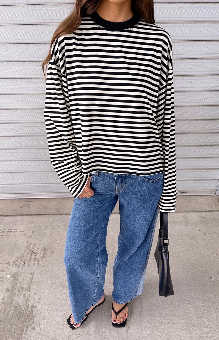 Relaxed fit black and white striped long sleeve top with a black crew neck