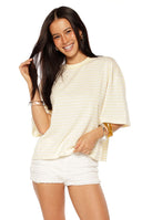 Girl taking a mirror selfie in a yellow and white striped oversized crop top a cute casual top for Summer