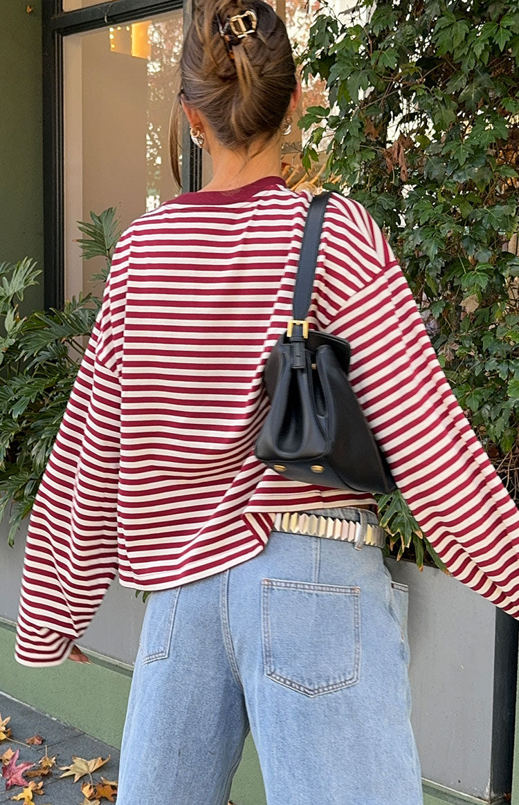 Rear view of a wine and white striped long sleeve top with a relaxed, slightly cropped fit and wide sleeves