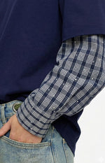 Close-up of the navy layered sleeve with a plaid inner layer featuring silver studs