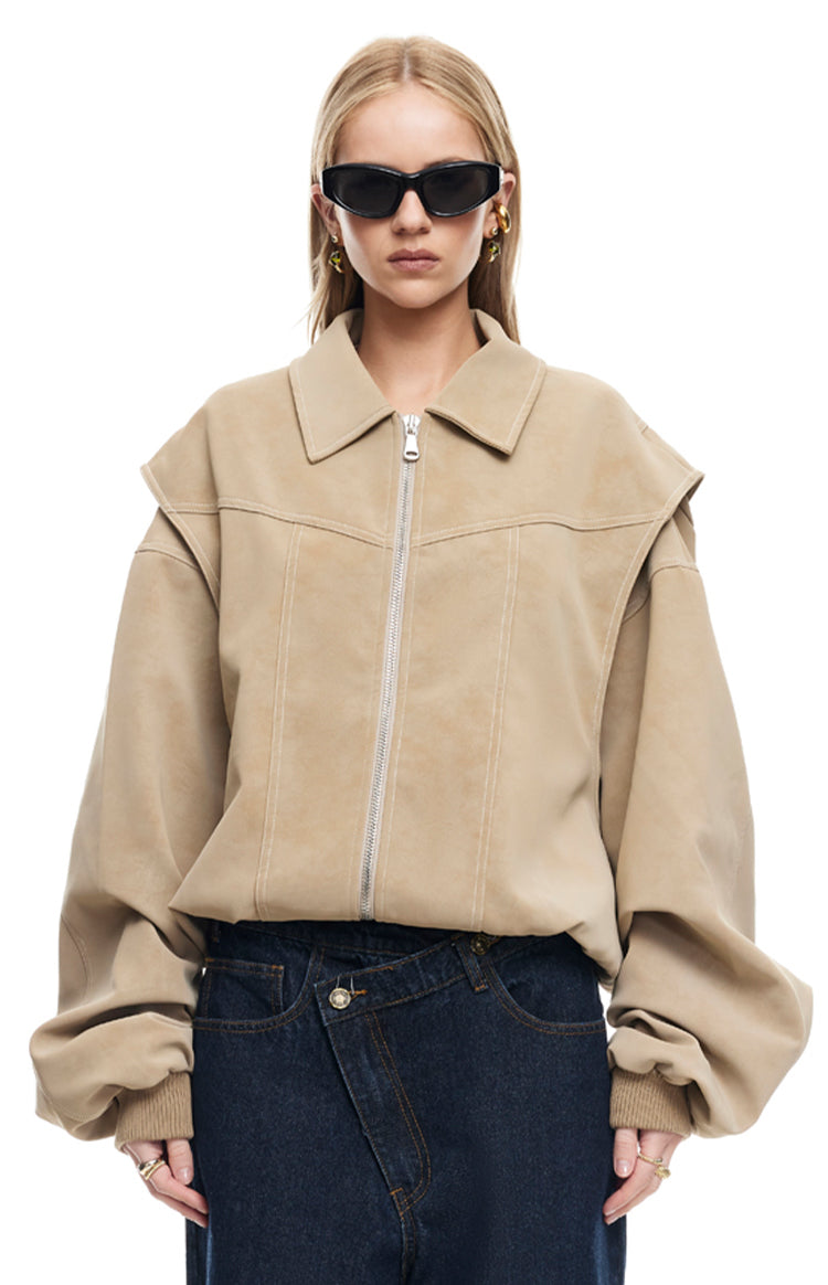 Front view of a latte suede-like bomber jacket with a pointed collar, silver zipper, and layered shoulder detail