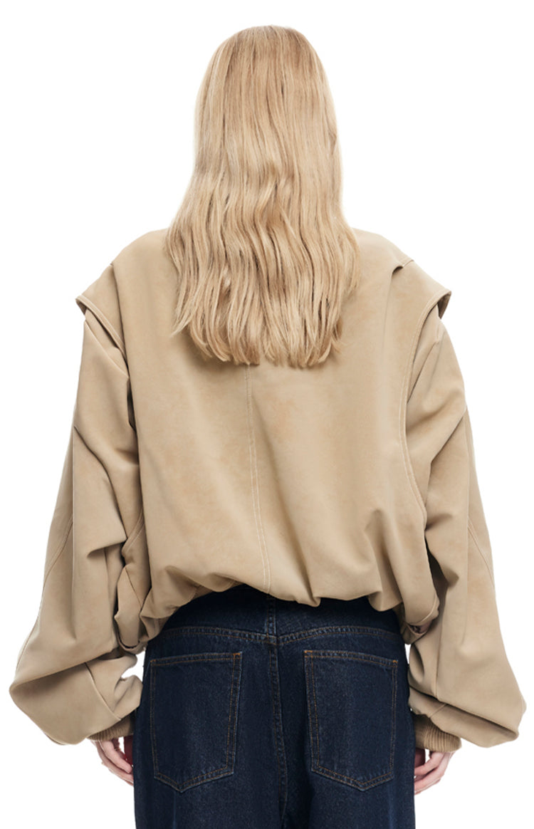 Rear view of a latte oversized bomber jacket with dropped shoulders and voluminous sleeves