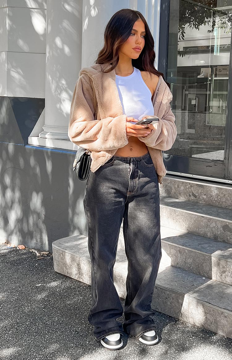 Front view of charcoal wash wide leg jeans with a relaxed fit, subtle fading, and pooling at the ankles