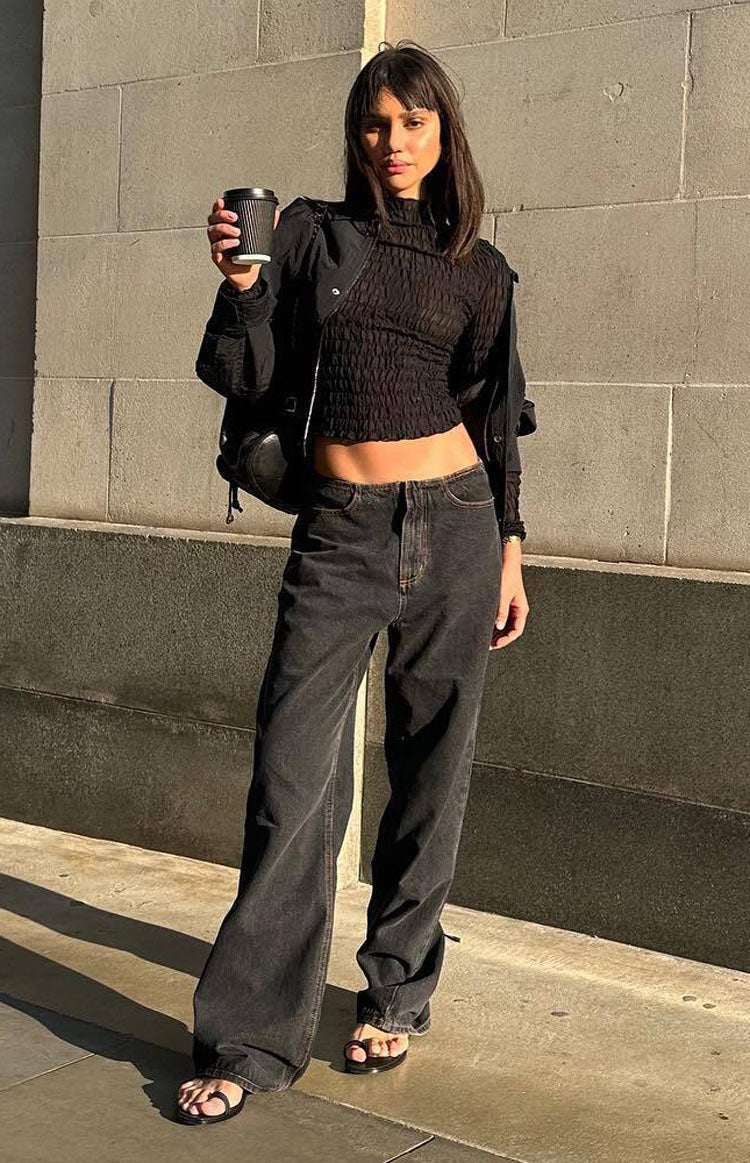 Full length view of charcoal wide-leg jeans with a relaxed fit and faded wash