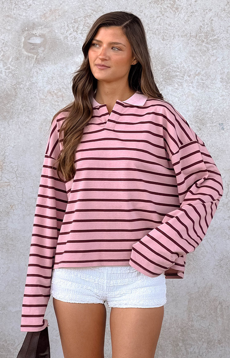 Blush pink and burgundy stripe jersey with a collared V-neck, dropped shoulders, and relaxed long sleeves