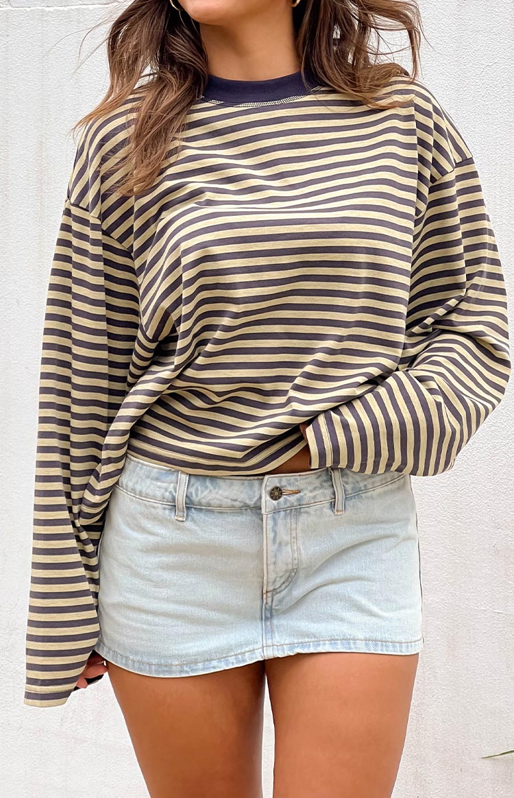 Light wash denim mini skirt with a single button closure and belt loops