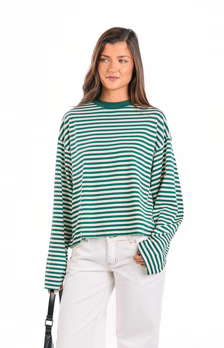 Front view of a moss green and white striped long sleeve top with a mock neck and relaxed, slightly cropped fit