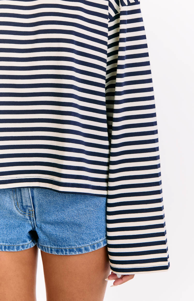 Close-up of the navy and white striped long sleeve top showing the straight hem and sleeve end