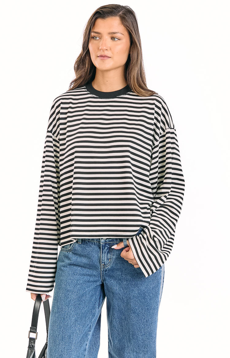 Relaxed fit black and white striped long sleeve top with a black crew neck and wide sleeves