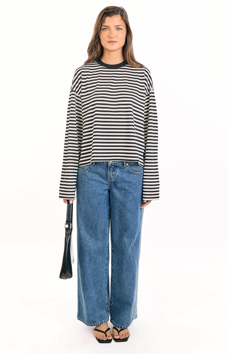 Front view of a black and white striped long sleeve top with a relaxed fit and a slightly cropped hem