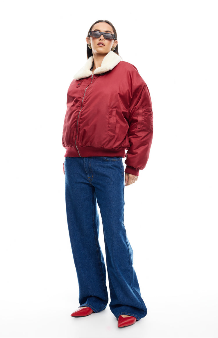 Oversized mulberry puffer jacket with a cream faux fur collar, silver zip, and ribbed cuffs and hem