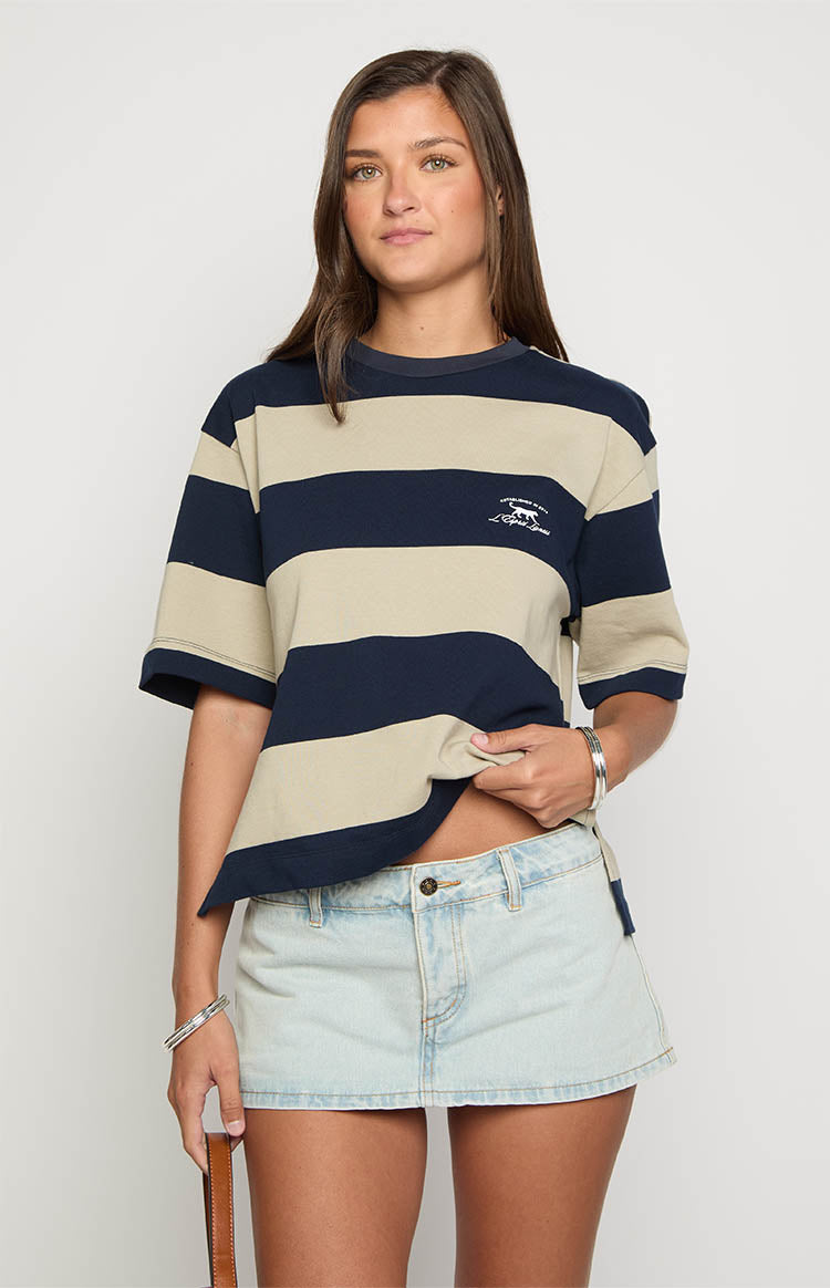 Front view of a light wash denim mini skirt with a low-rise waist and single button closure