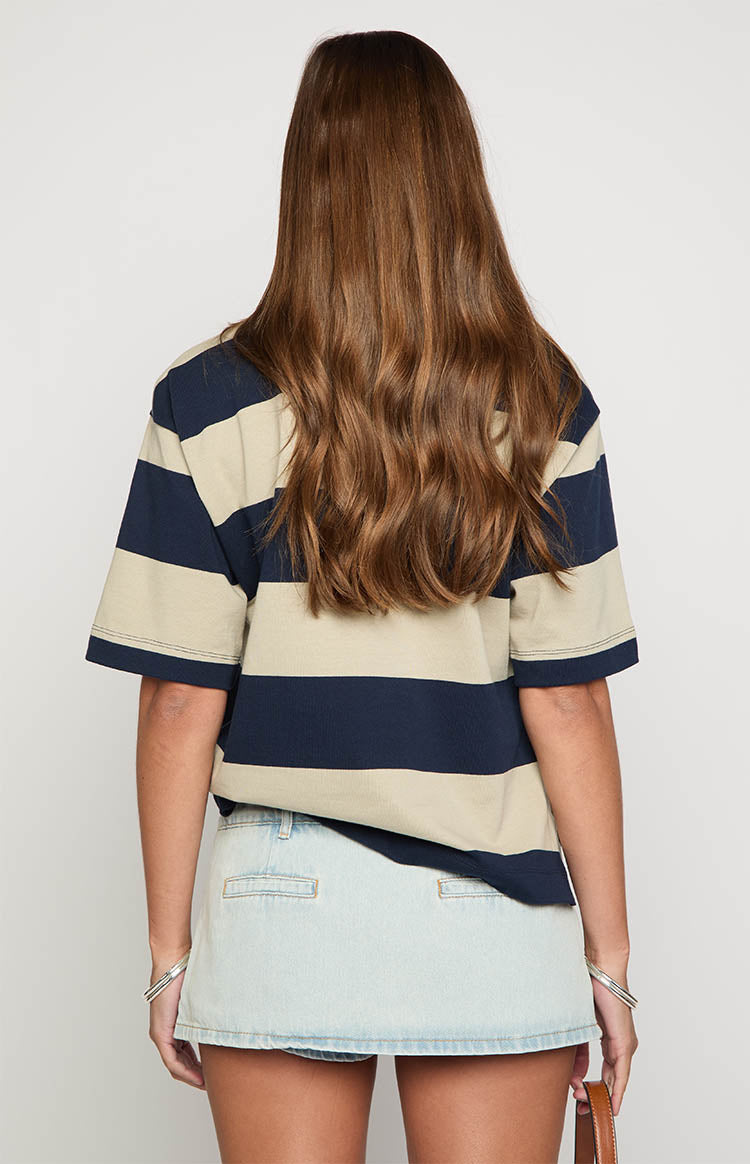 Rear view of a light wash denim mini skirt showing stitched rectangular back pockets and a straight hem