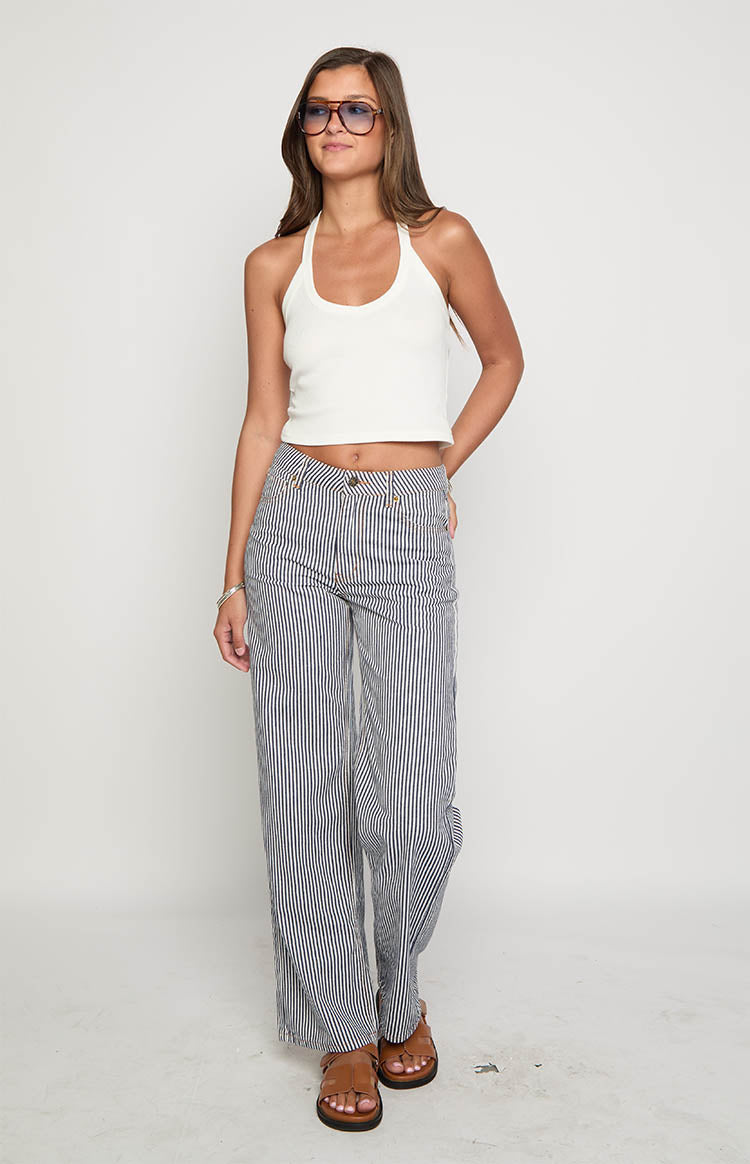 Full length front view of navy and white pinstripe wide-leg jeans with a relaxed fit and high waist