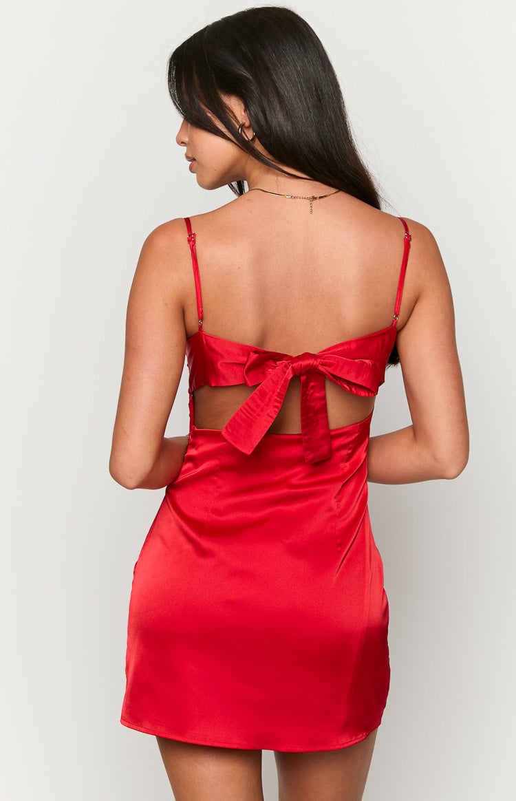 Rear view of a red satin mini dress with an open back, tie-back bow, and side cutouts