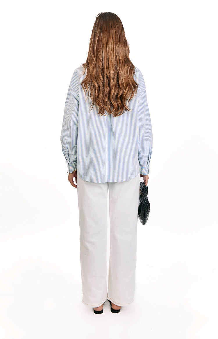 Back view of the blue and white stripe button up shirt with a relaxed fit and long cuffed sleeves