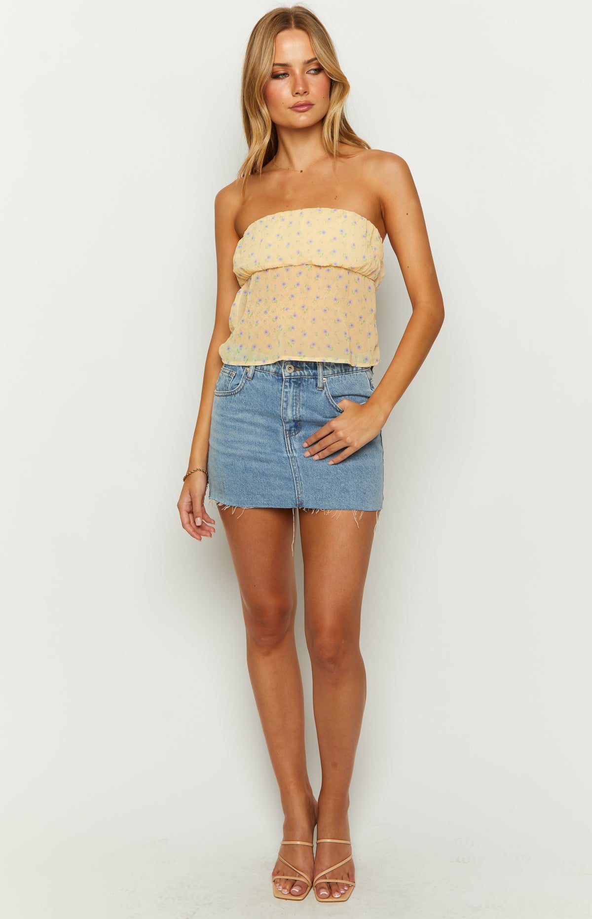 Yellow floral strapless top with a shirred band at the bust and a loose, flowy body