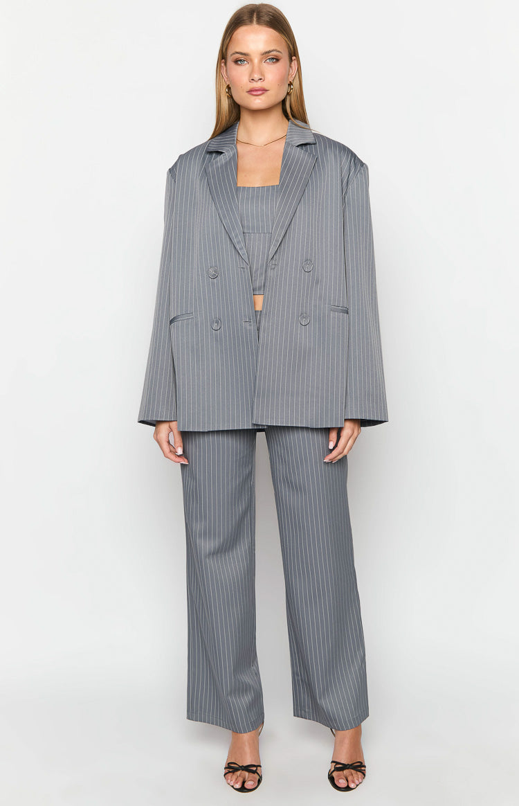 Front view of a grey pinstripe bandeau crop top with a straight neckline, worn under an open blazer