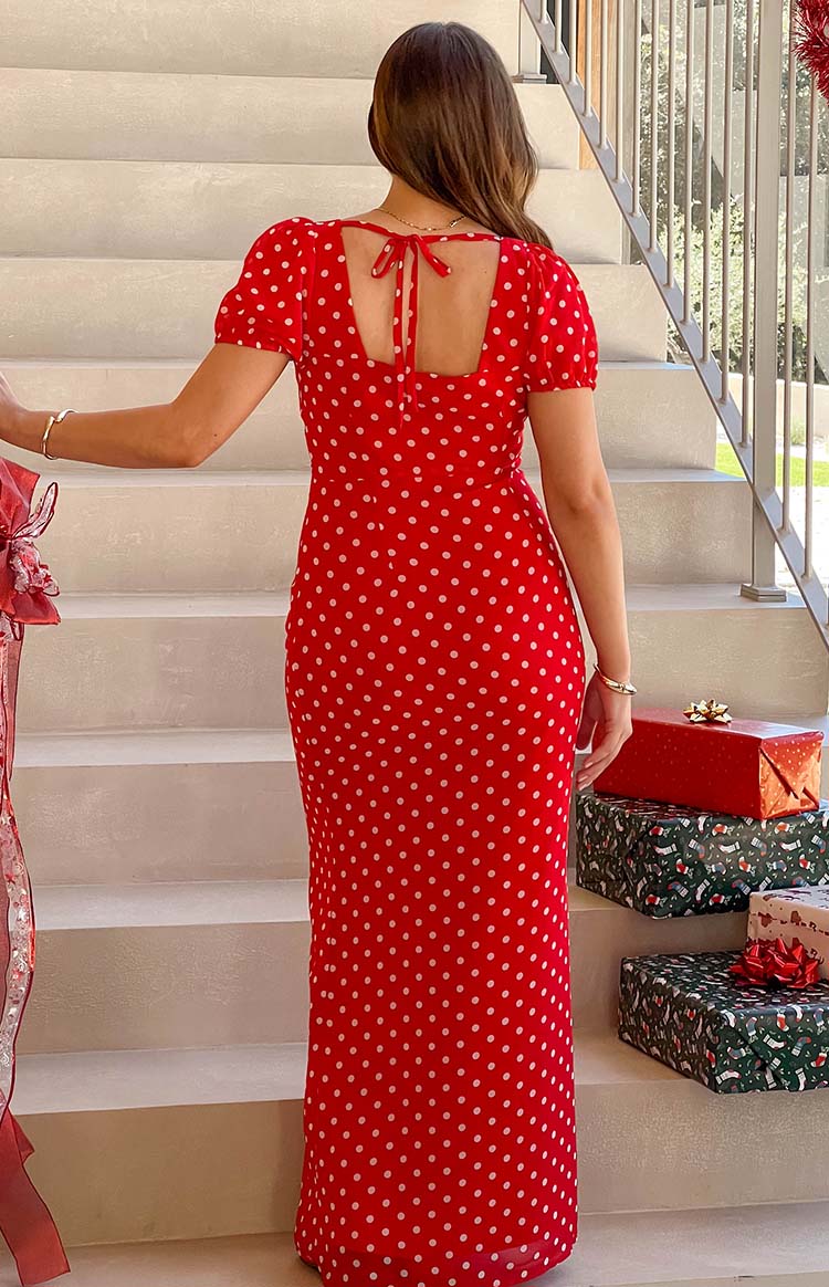 Rear view of the red polka dot maxi dress with short puff sleeves and a square tie-back neckline