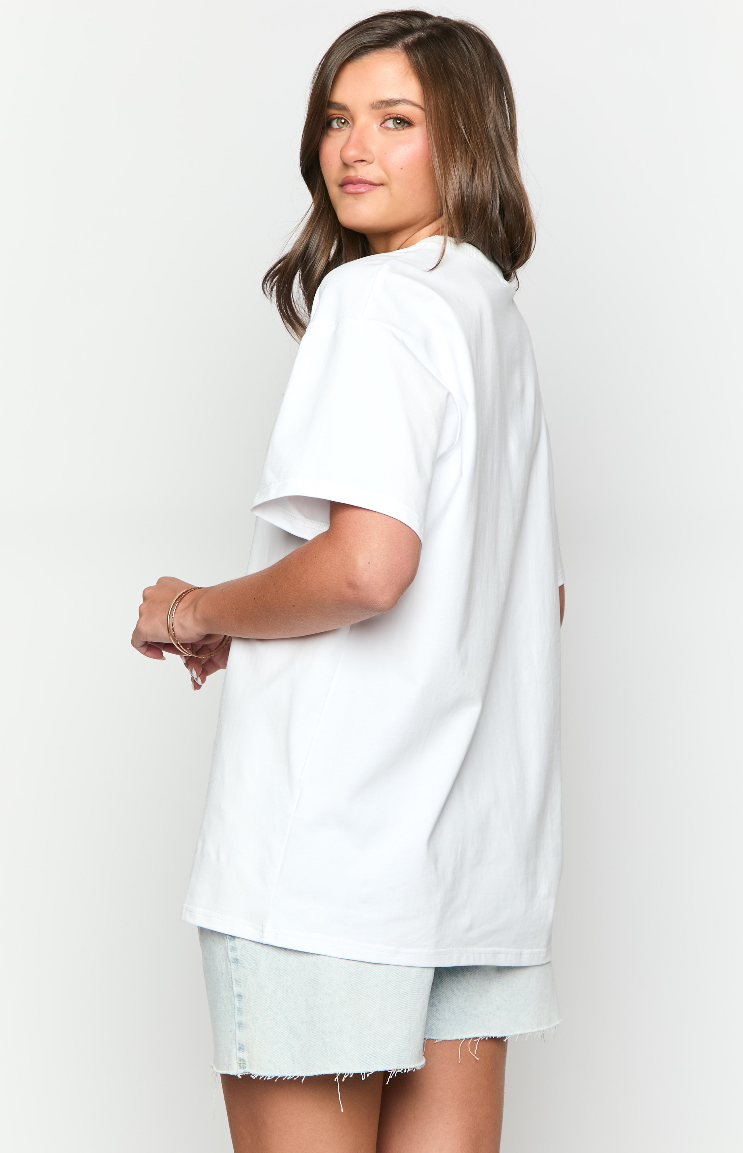 Rear view of a white oversized tee with short sleeves and a plain back