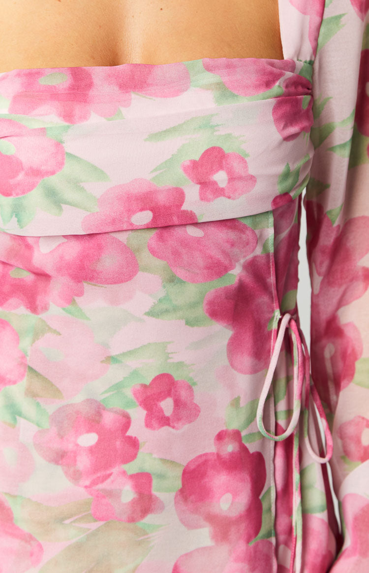 Close-up of the pink floral print fabric with green leaves, showing the ruched side panel and delicate drawstring ties