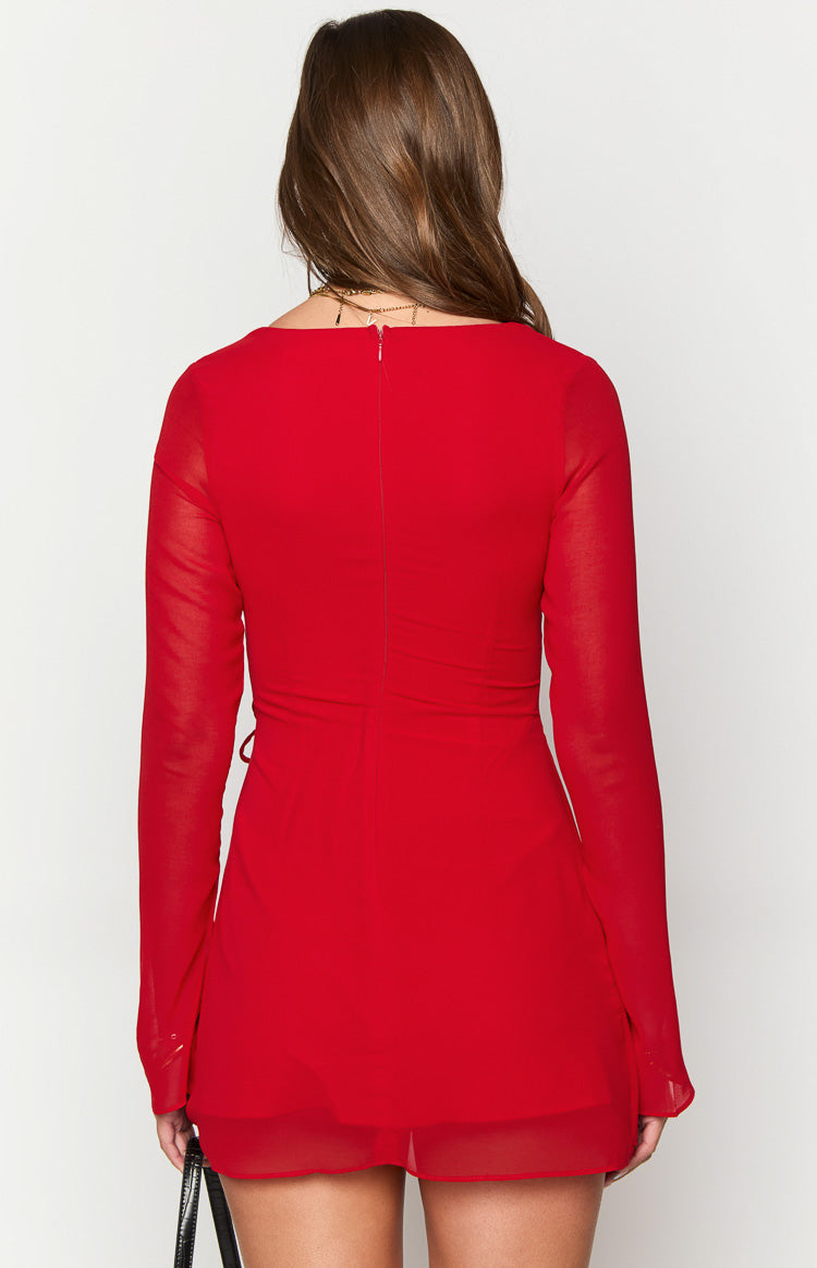 Rear view of the red long sleeve mini dress showing an invisible back zipper, central ruched detail, and sheer sleeves