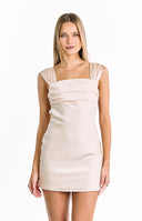 A sleeveless cream-colored mini-dress with a square neckline wide ruched shoulder straps and a draped bodice. Our dress is suitable for a semi-formal event or a party.