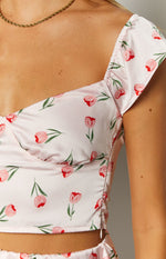 Close-up of the pink satin top's ruched shoulder strap, structured bust, and red tulip print