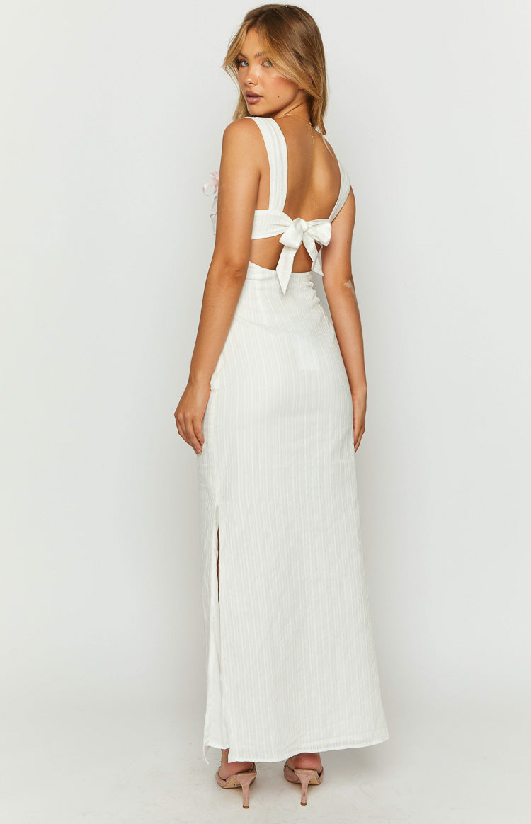 Rear view of a white textured maxi dress with a tie-back detail, cutouts, and a side slit