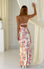 Rear view of a yellow floral satin maxi dress with a strapless cut-out back and shirred elastic band