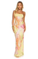 Full-length view of our model wearing a strapless maxi dress in a vibrant yellow color. This maxi features a contrasting yellow ribbed band at the bust and is printed with large watercolor-style pink and orange flowers throughout the skirt.