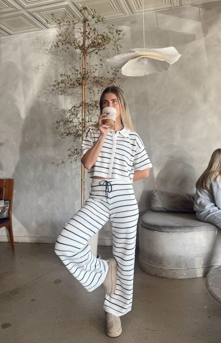 White and navy stripe cropped knit sweater with a polo collar and short sleeves, showing the ribbed texture