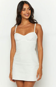 White mini dress with a sweetheart neckline and floral embellished straps