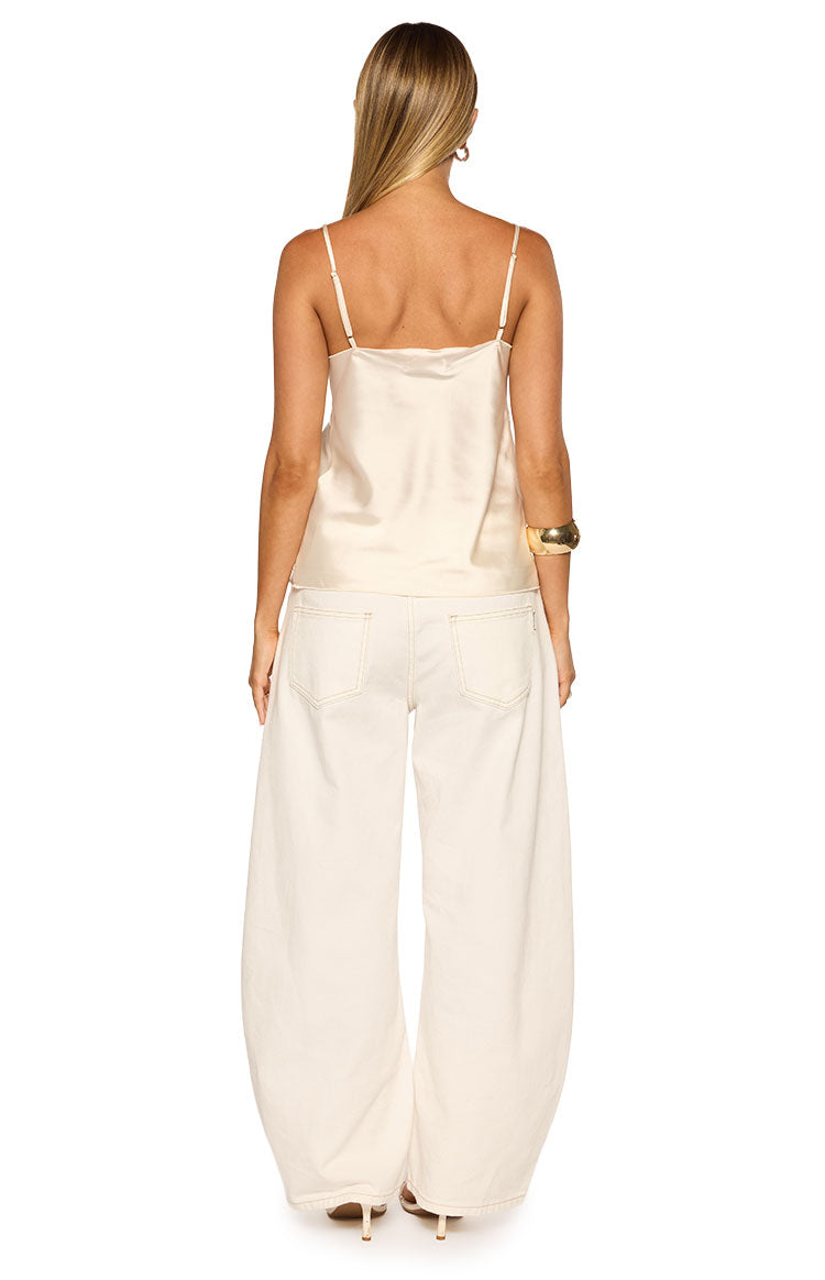 Rear view of a cream satin cami top with thin spaghetti straps and a straight back neckline