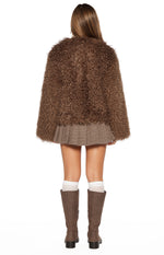 Rear view of the brown shaggy fur jacket, showing its textured back and cropped hem