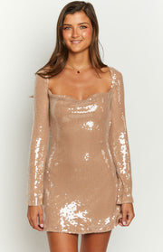 Close-up of the champagne sequin mini dress showing the sweetheart neckline and long sleeves