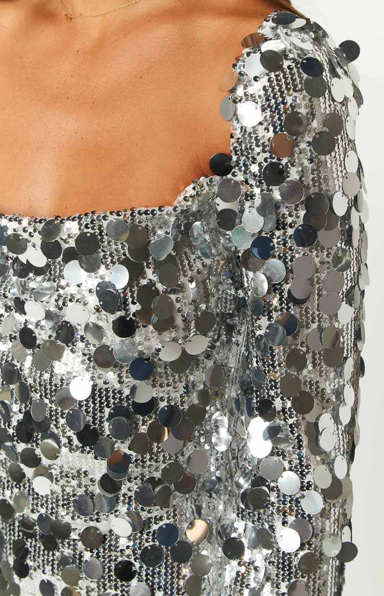 Close-up of the silver sequin fabric, showing the large round sequins and the square neckline