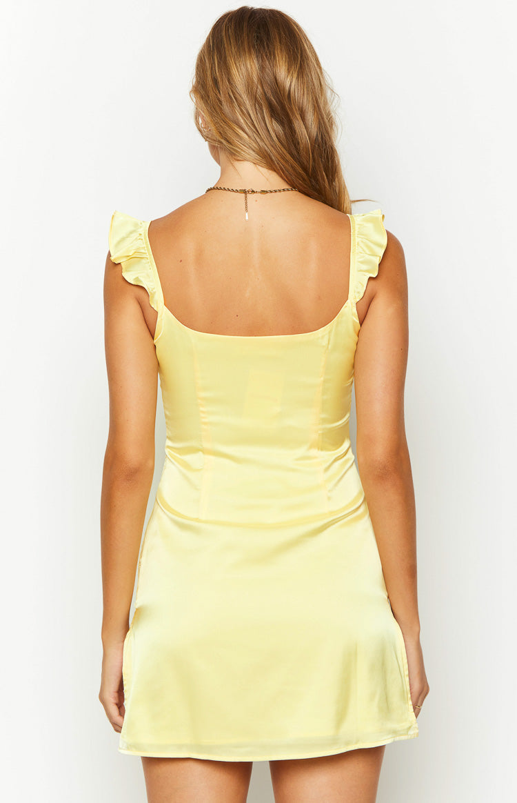 Rear view of a yellow satin mini dress with a square back neckline and ruffled shoulder straps