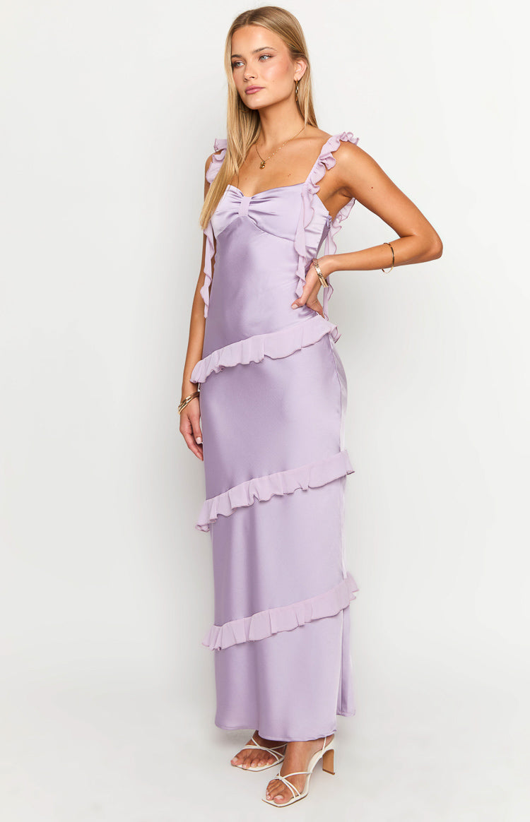 Side view of a purple satin maxi dress with a bow bust detail and tiered ruffles down the skirt