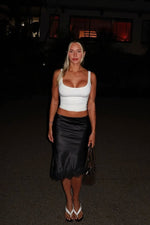 Black satin midi skirt with a subtle A-line silhouette and delicate lace trim at the hem