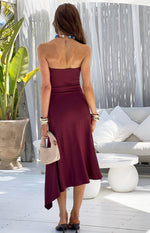 Rear view of a plum strapless midi dress with an asymmetrical hemline