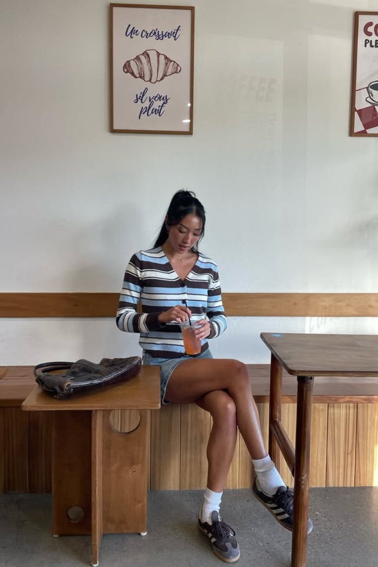 Full front view of a fitted brown, blue, and white stripe button-down cardigan with a V-neck and long sleeves