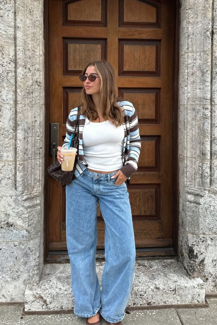 Front view of a brown and blue stripe button down cardigan worn open, showing its relaxed fit