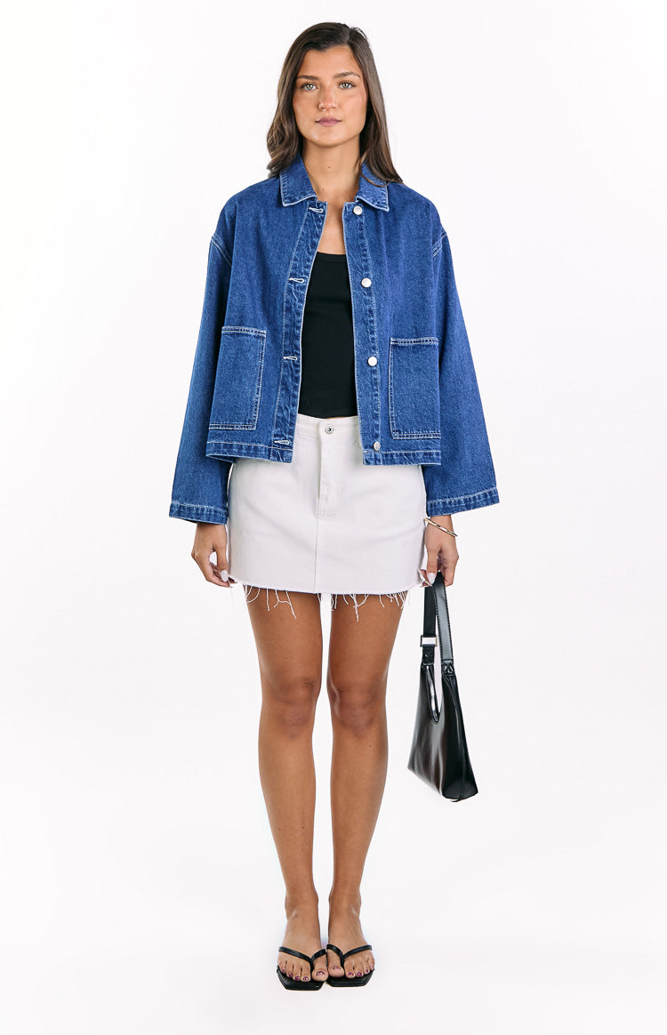 Relaxed fit mid wash denim jacket with a classic collar, white contrast stitching, and large front patch pockets